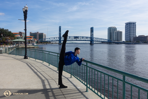 Dancer Daren Chou stretching while taking in St. Johns River, just outside Jacksonville, Florida’s Times-Union Center for the Performing Arts. (Photo by dancer Louis Liu)